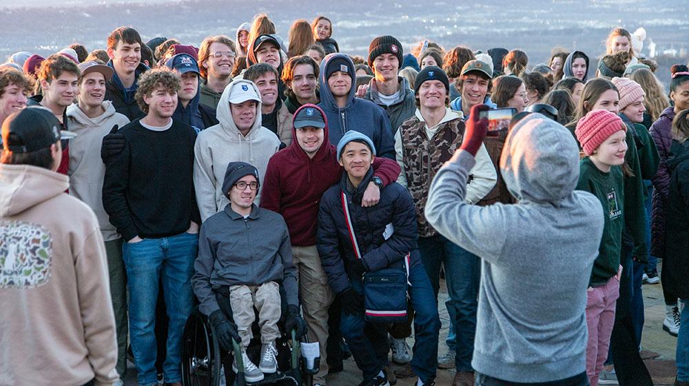 group of students taking a photo on a scenic overlook