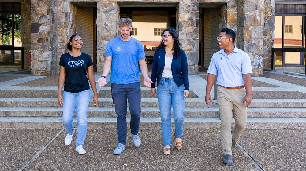 4 students walking and talking